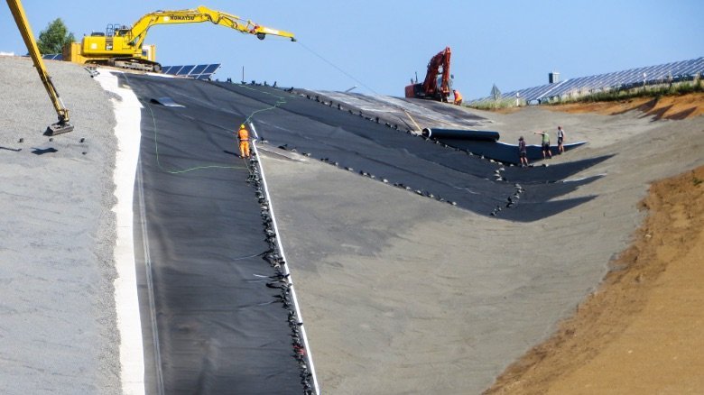 Installation of the HDPE liner by using a long arm excavator